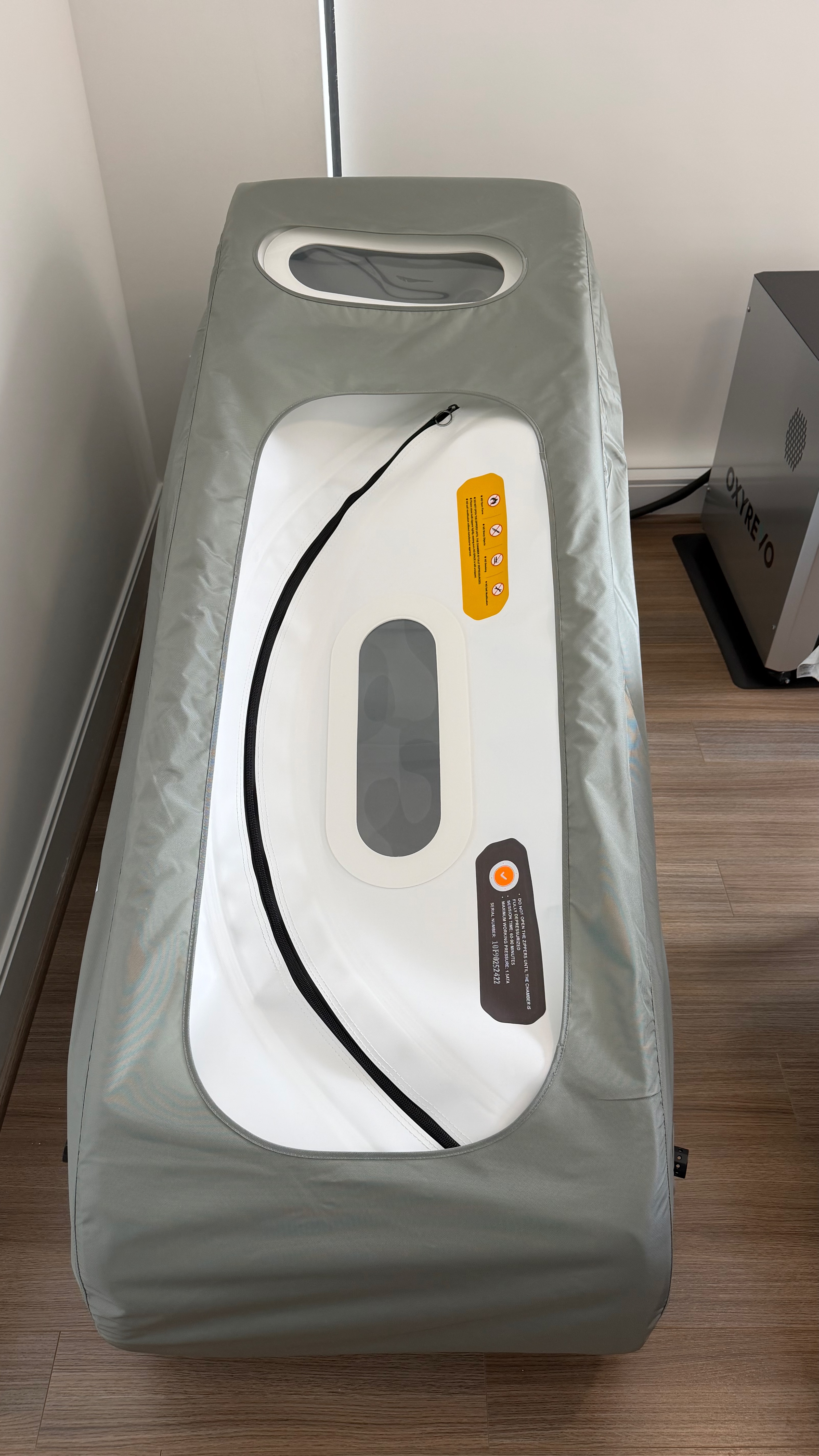 Used hyperbaric chamber Atlanta — top-down view of the OXYREVO Forward90 Pro showing the unique curved YKK zipper opening, top viewing window and warning labels in pristine like-new condition. Actual unit for sale in Buckhead, Atlanta GA.